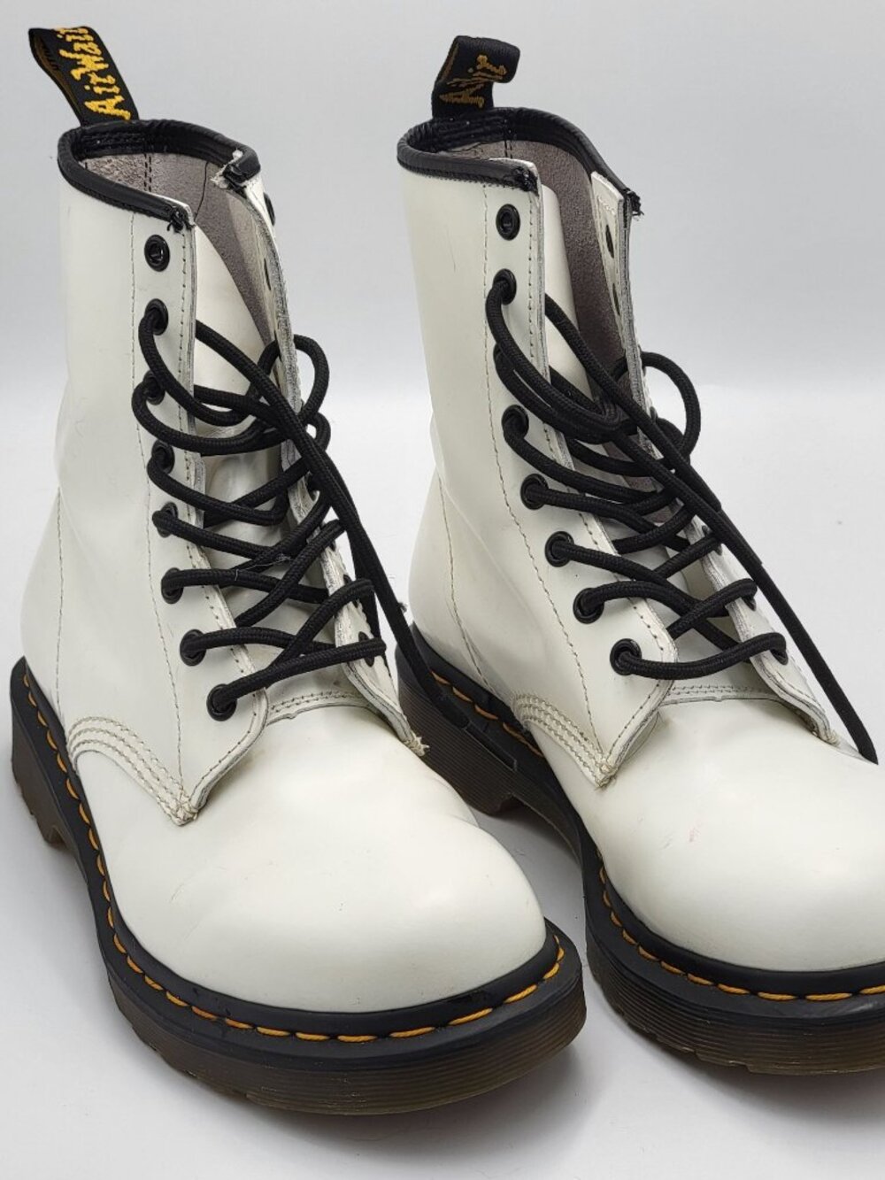 White Dr. Marten AirWairpatent leather rubberbouncing sole lace up ankle boots.
